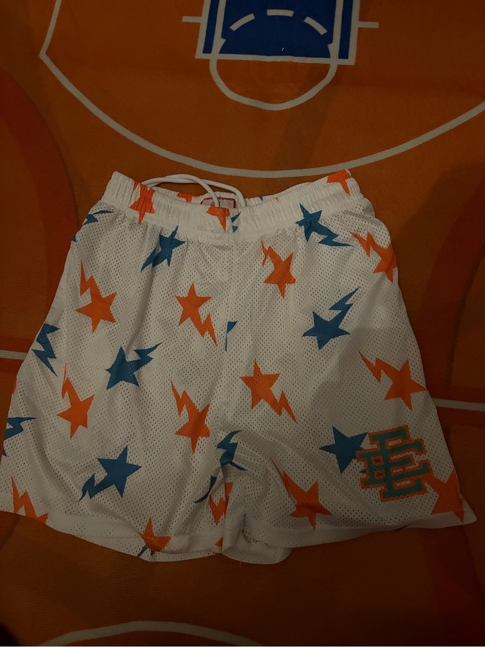 Eric Emanuel White Basketball Shorts with Orange & Blue Stars